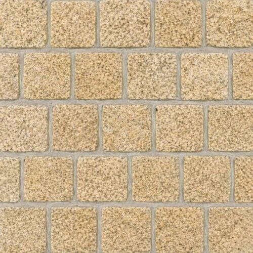 Diamond Gold Granite Cobblestone Pavers showing golden beige speckled cobbles with textured faces in offset rows